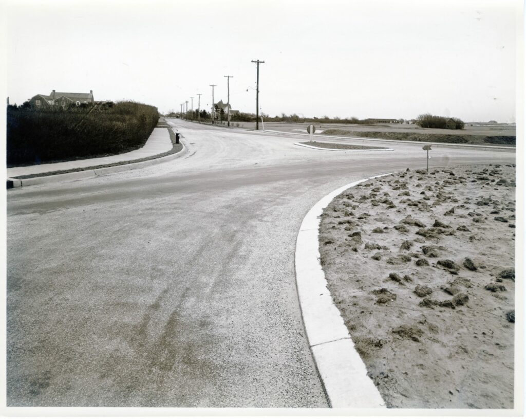 Niamogue Lane-Post Lane roundabout, looking east. Quogue Field Club golf course, post-1938 Hurricane, on right. House in the center built by Abram S. Post, ca. 1890. House at left, # 11 Niamogue was built ca. 1928.