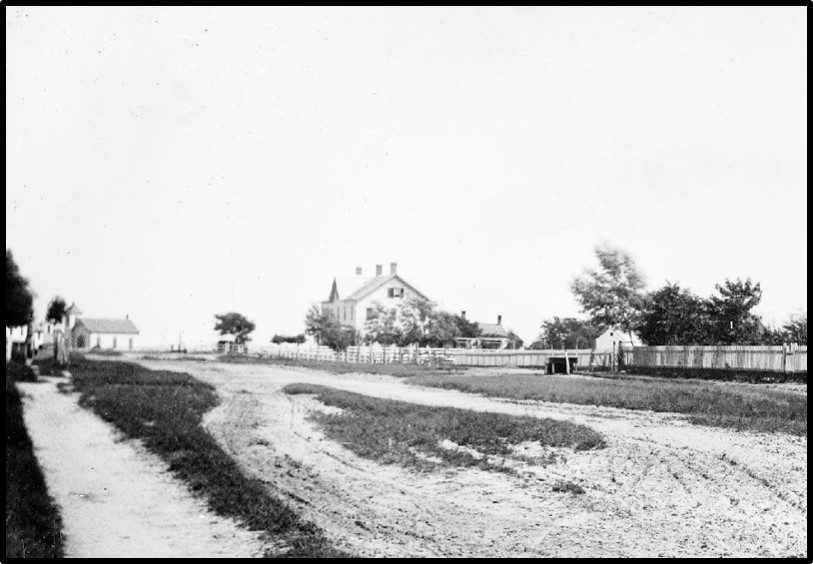 
More detail: the Jessup Pierson House stood on the southwest corner of Quogue Street and Jessup Lane. The rear portion was built by Egbert Jessup in 1842 and enlarged and remodeled to board summer guests in the 1880s. Mrs. Florence Pierson, born a Jessup, ran the boarding house until the early 20th century. Now a private residence, it is said that many of the bedrooms still have the old boarding house room numbers on the doors.

At left is the Presbyterian Chapel on the corner of Beach Lane.